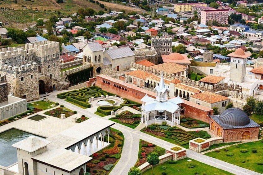 A historic town with a castle, a church, and a well-maintained garden. 5