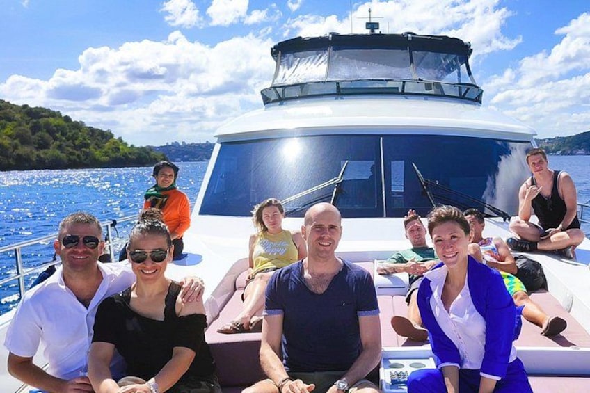 A group of people on a boat with a lake and hills in the background. 5