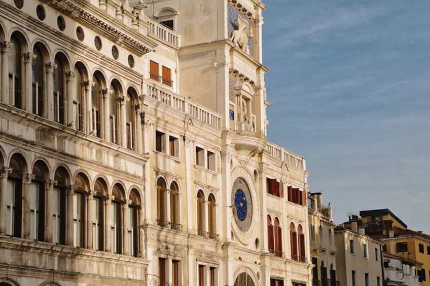 A historic building with arched windows and a clock tower. 2