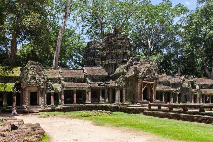 An ancient temple complex with intricate stone carvings and a central tower. 1