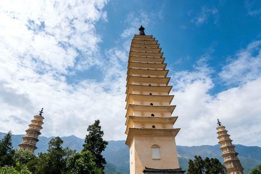 A large pagoda with multiple tiers, surrounded by trees and mountains in the background. 1