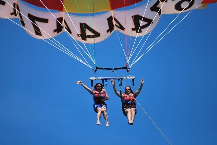 Two people paragliding with a parachute. 1