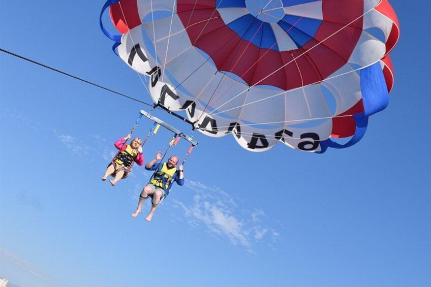 Two people skydiving with a parachute. 5
