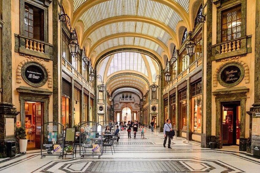 A spacious indoor market with high ceilings and ornate architecture. 2