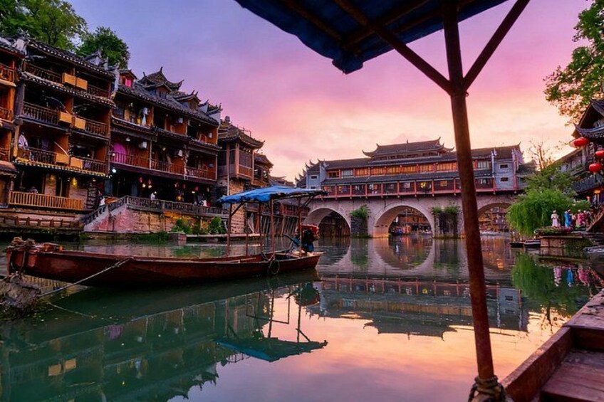 Traditional Chinese architecture, a river with boats, and a reflection of the buildings. 1