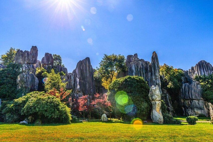 A landscape with rock formations, trees, and a clear sky. 1