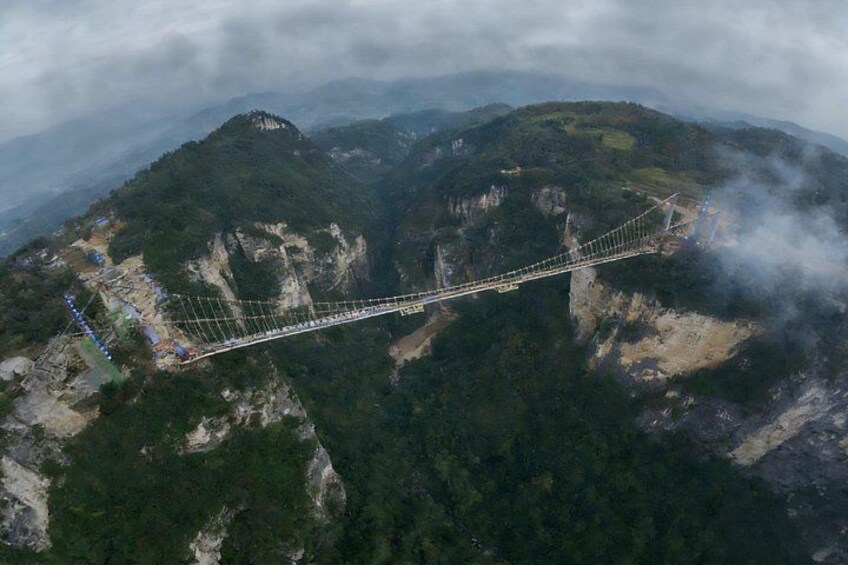 A suspension bridge spanning a deep gorge with steep cliffs on either side. 3