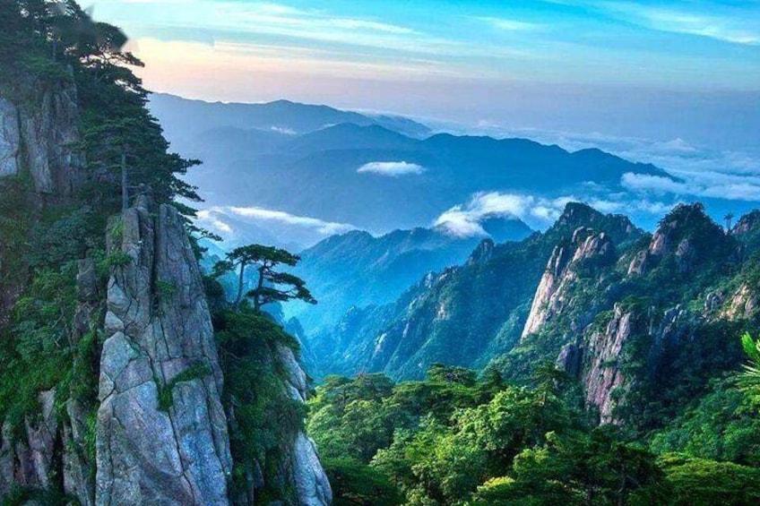 A mountainous landscape with dense forests and rocky cliffs. 5