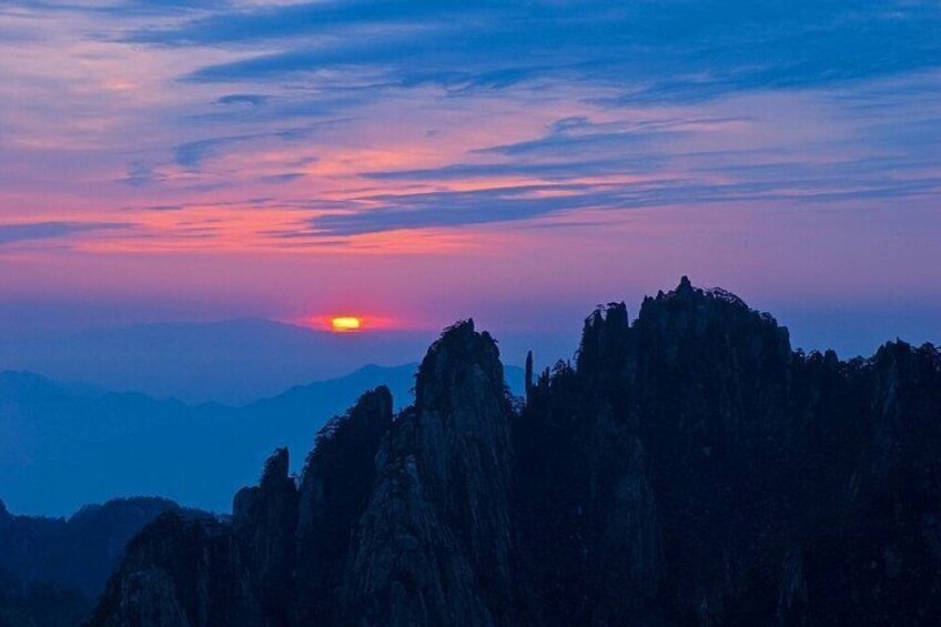 A sunset over rocky mountains. 2