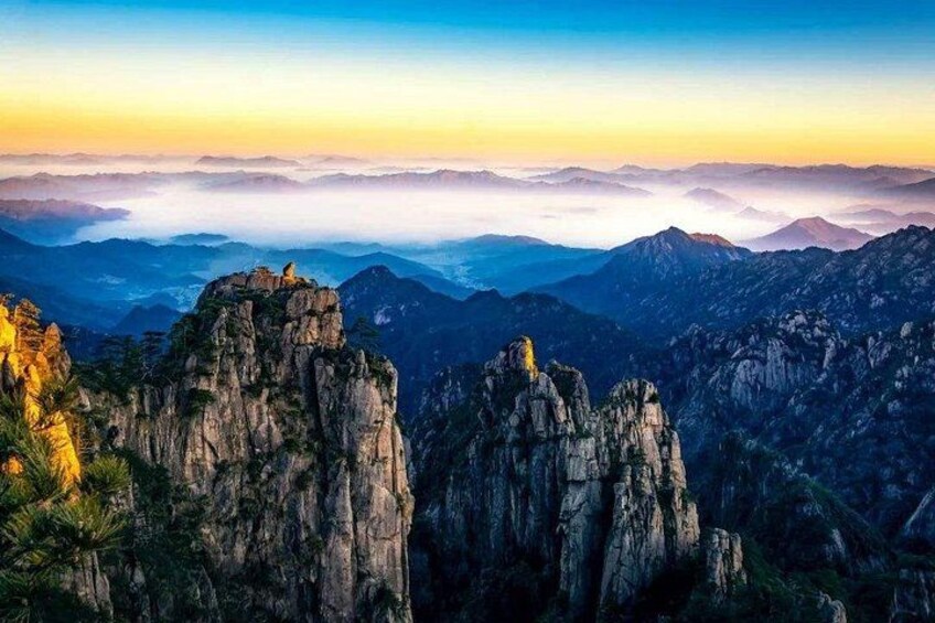 A mountainous landscape with rocky peaks and a clear sky. 4