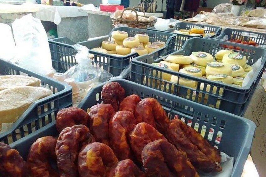 A market stall with various cheeses and cured meats. 4