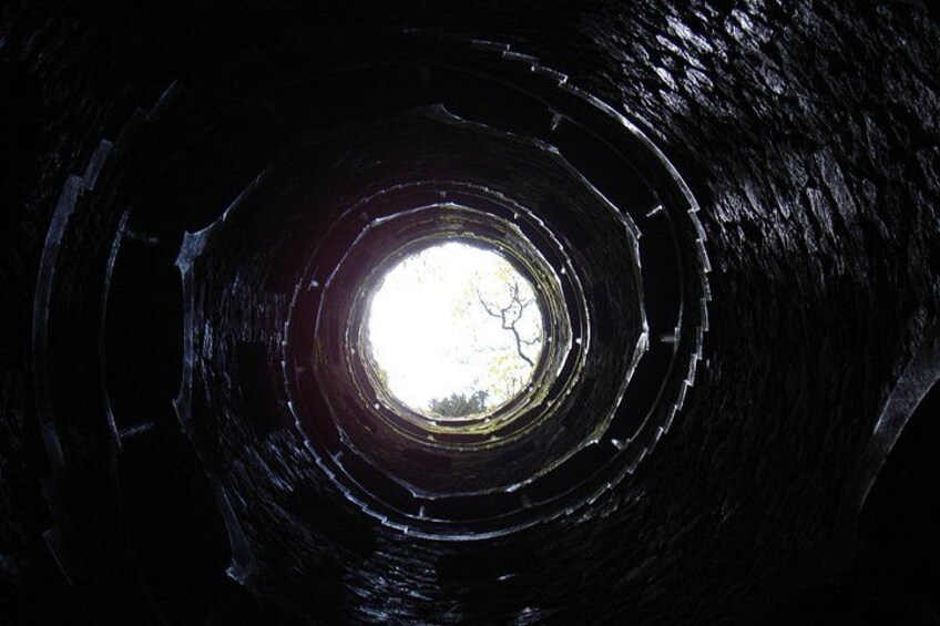 A circular tunnel with a light source at the end. 5
