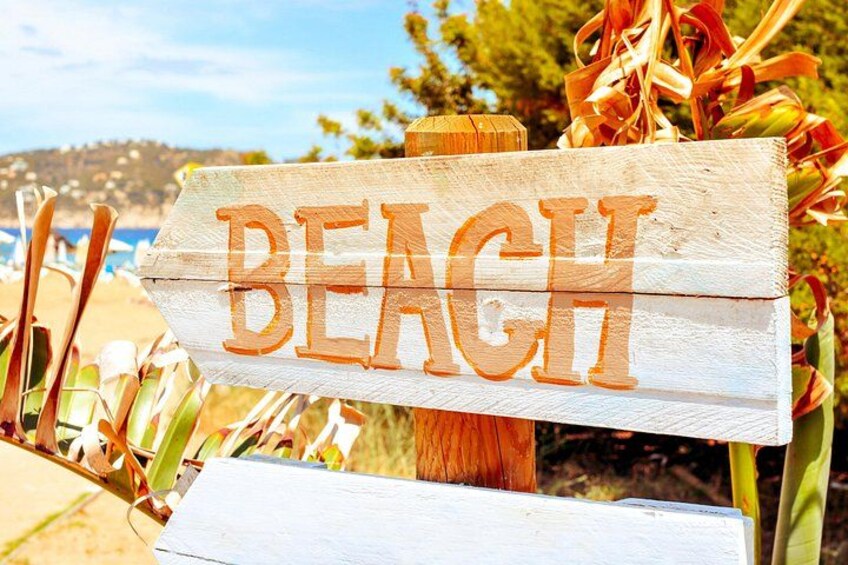 A wooden sign with the word 'BEACH' in large letters. 5