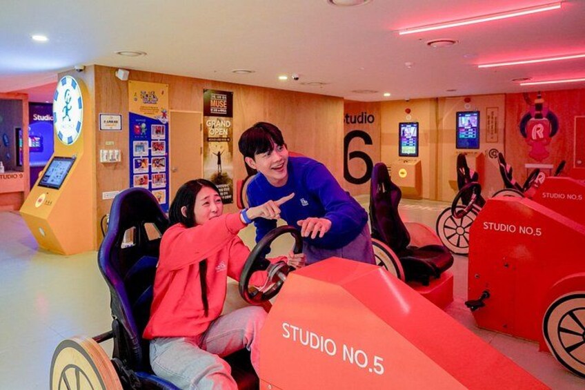 A racing simulator with a steering wheel and a track. 4
