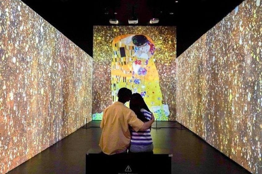 An art installation with a large projection of a painting, surrounded by textured walls. 3