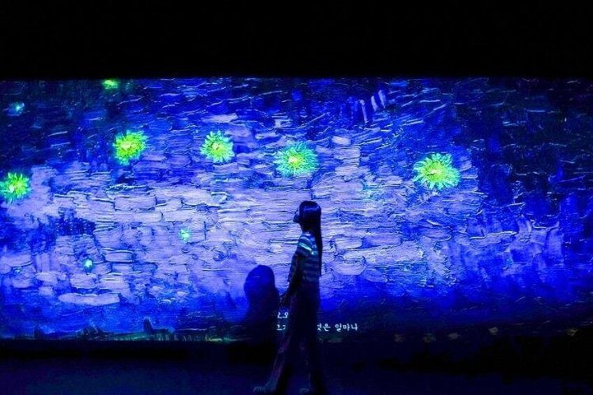 A person walking in front of a textured wall with blue and green lights. 2