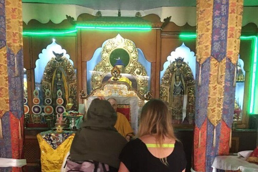 A religious shrine with ornate golden decorations and a central figure. 1