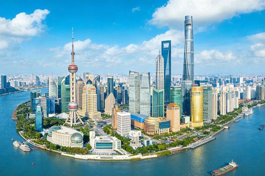 A cityscape with a prominent tower, modern skyscrapers, and a river. 3