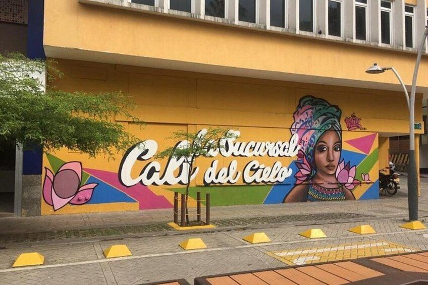 A mural with text and a woman's portrait on a building. 2