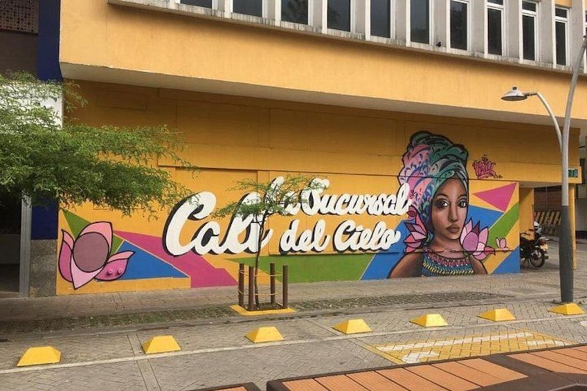 A mural with text and a woman's portrait on a building. 2