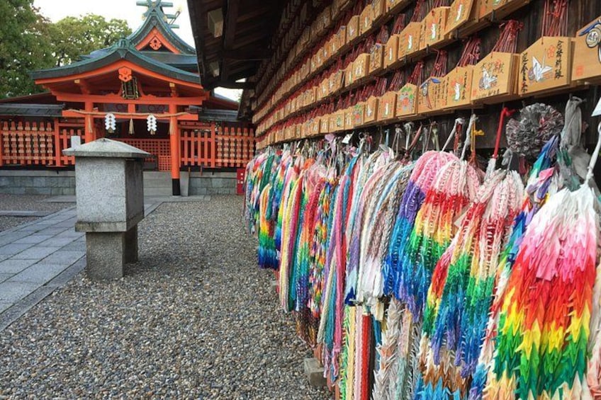 A traditional Japanese temple with colorful umbrellas and boxes. 3