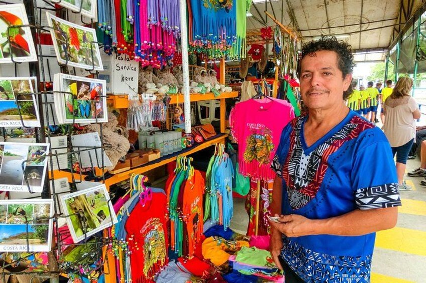 A person standing in front of a colorful display of items, including clothing and accessories. 5