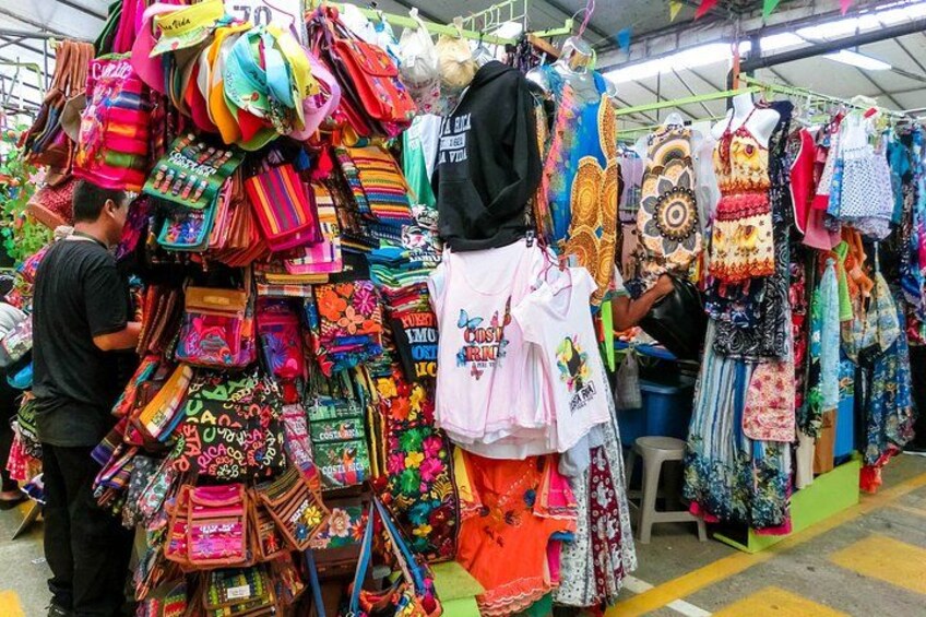 A market stall with colorful bags and accessories. 4