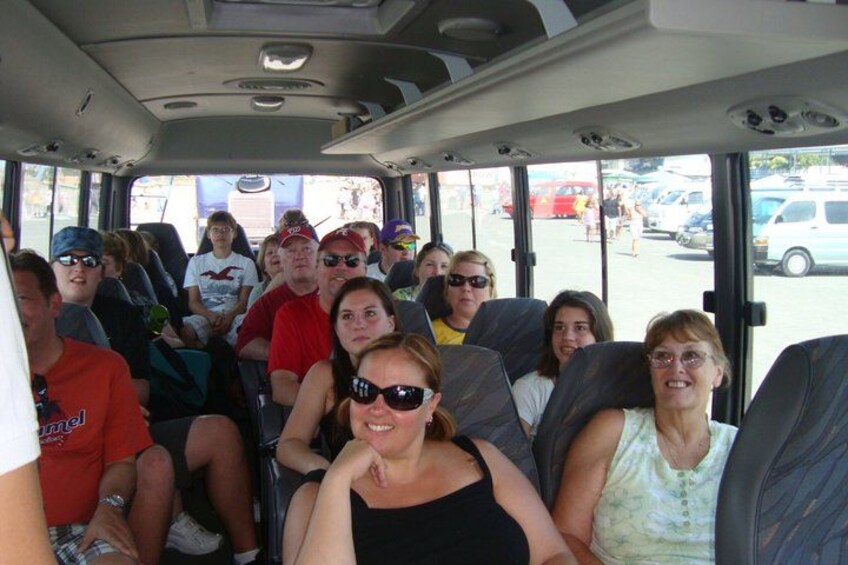 A group of people seated inside a bus. 2