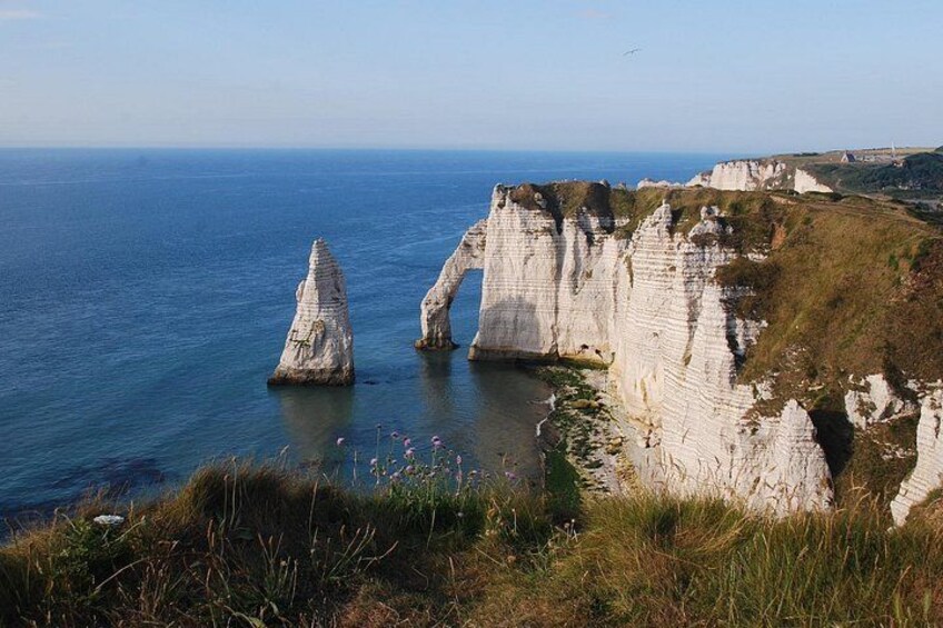 White cliffs, a clear blue sea, and a grassy landscape. 2