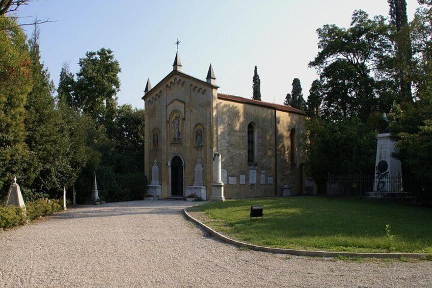 Une église avec un chemin de gravier menant à l’entrée, entourée d’arbres et d’une zone herbeuse. 2