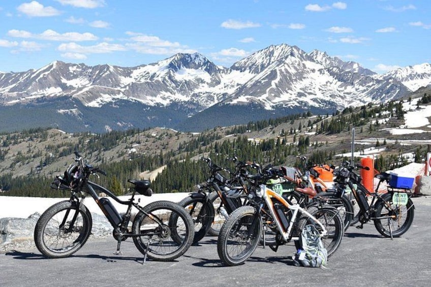Una fila di biciclette parcheggiate con un paesaggio montuoso sullo sfondo. 5