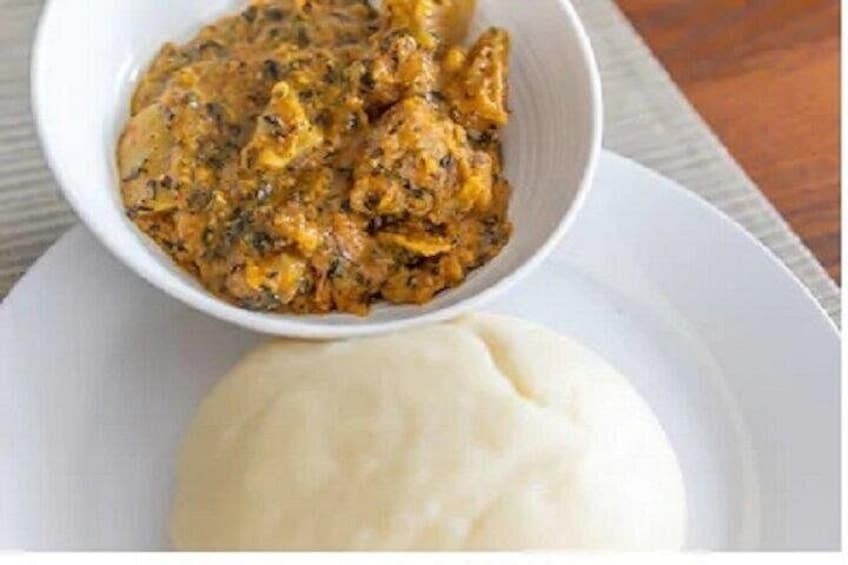 A bowl of stew and a mound of white food on a plate. 3