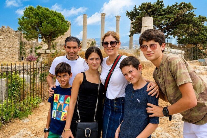 A family of six at an archaeological site with ancient ruins and columns in the background. 2