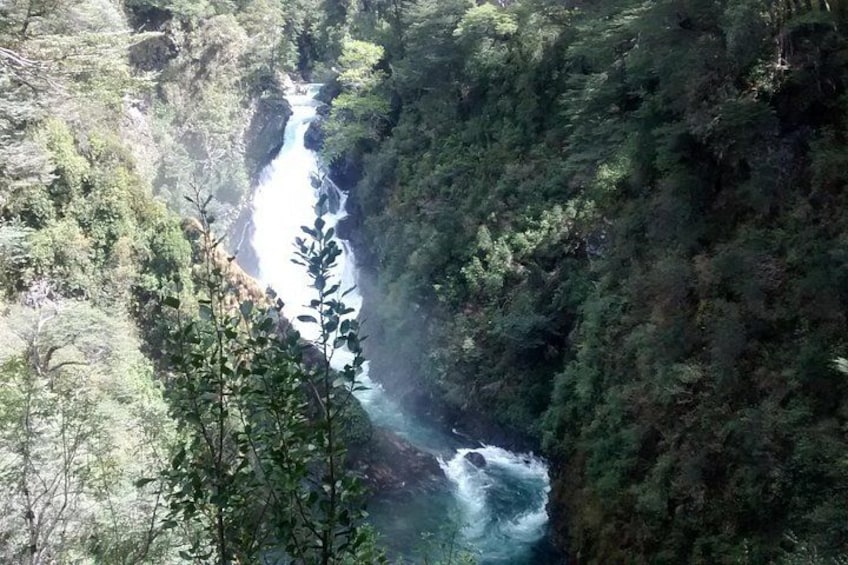 A river flowing through a forested canyon. 2