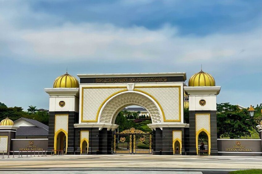 A grand entrance with a large archway, two domed towers, and a gated entrance. 4