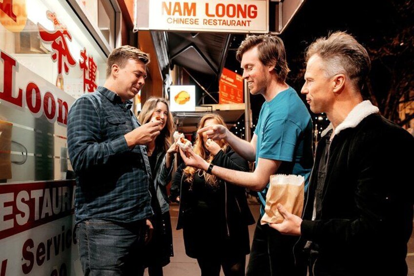 People eating at a Chinese restaurant named NAM LOONG. 1