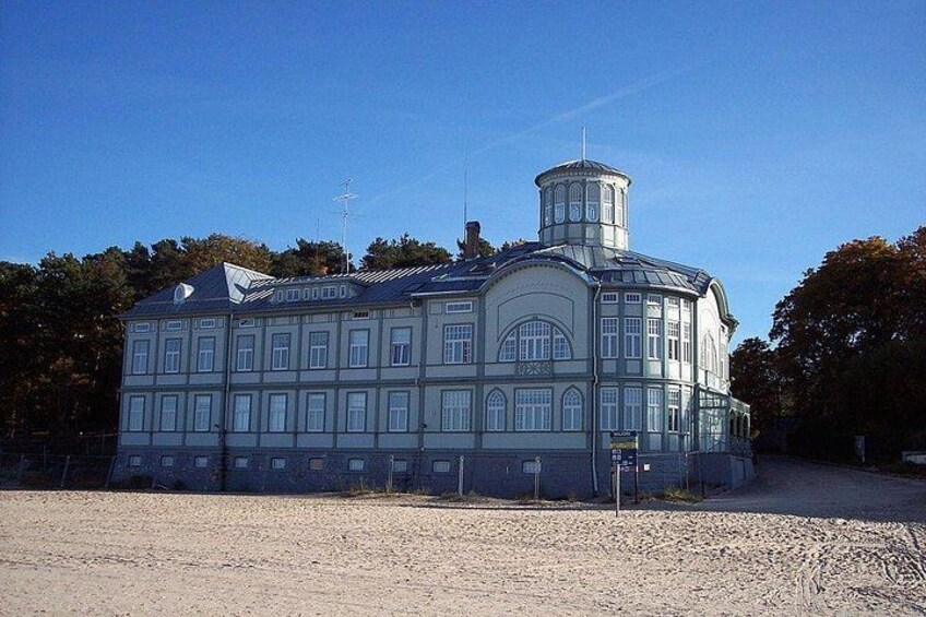 A large, historic building with a central tower and multiple windows. 1