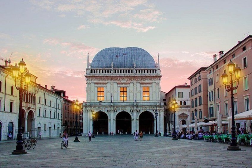 A historic building with a dome, arched entrances, and surrounding buildings. 5