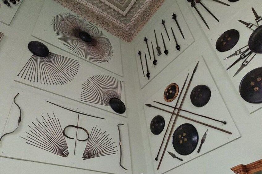 A ceiling with various medieval weapons and shields. 4