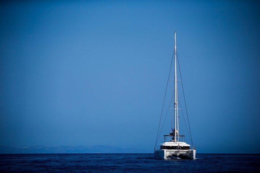 A sailboat on calm waters with a clear sky. 4