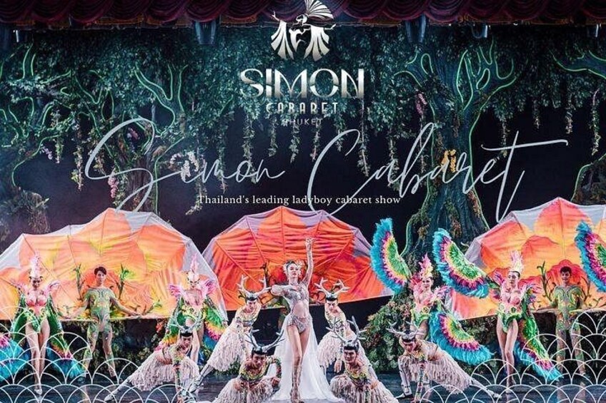 A stage with performers in colorful costumes and a backdrop with trees and text. 3