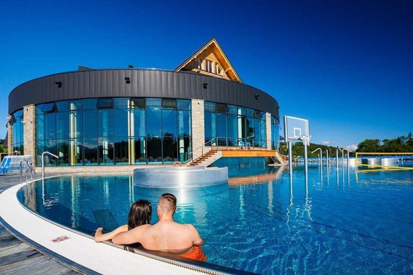 A swimming pool with a modern building in the background. 5