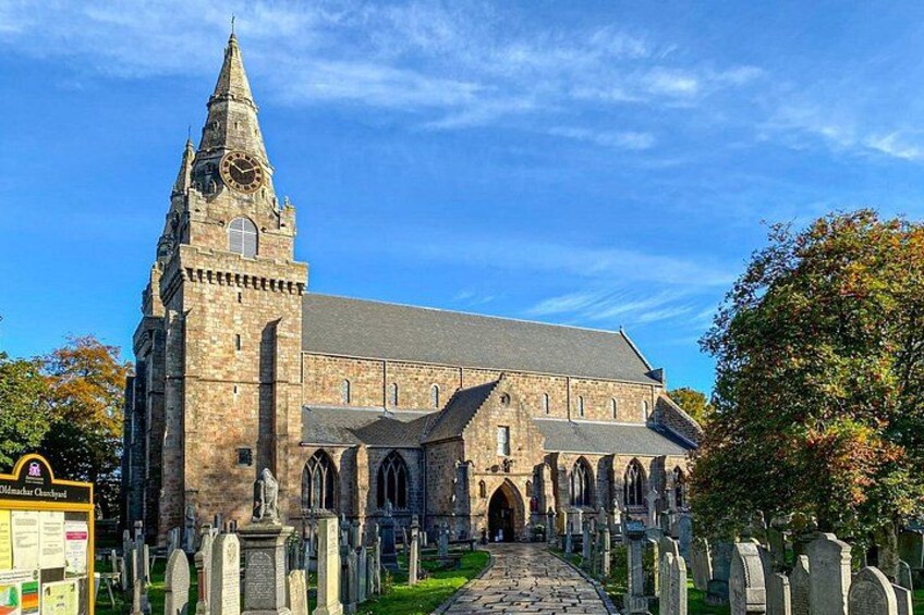 A historic church with a tall tower and a long pathway leading to it. 5