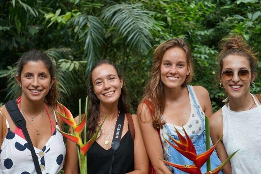 Four individuals outdoors with lush greenery in the background. 5