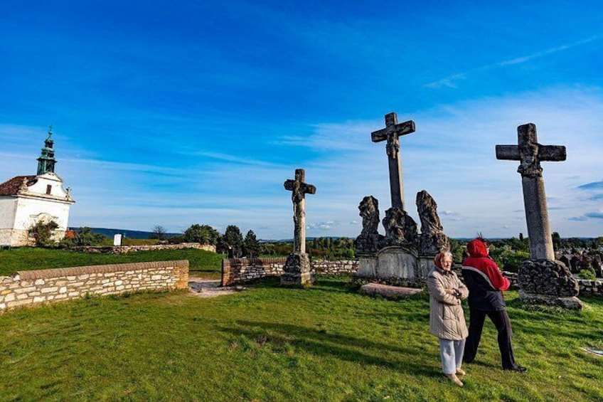 A cemetery with multiple crosses and a church in the background. 4