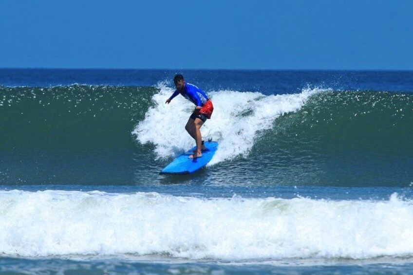 A person surfing a wave in the ocean. 2