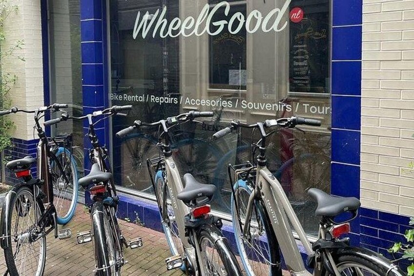 A storefront with the sign 'WheelGood' and bicycles parked outside. 5
