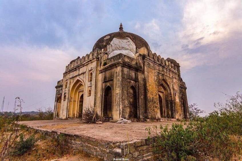 An old, dilapidated building with a dome and arched windows. 3