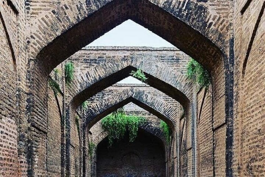 A brick archway with a tunnel-like structure. 2