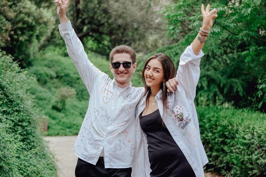 Two people in a park with greenery and a path. 4